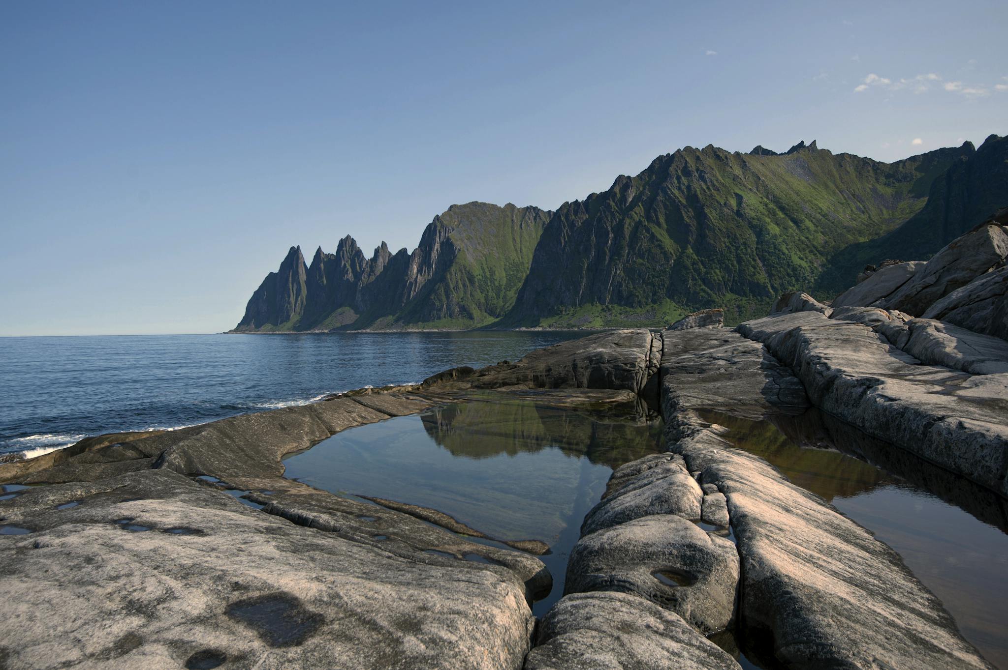 Scenic view of mountainous coastline and sea at Senjahopen, Norway.